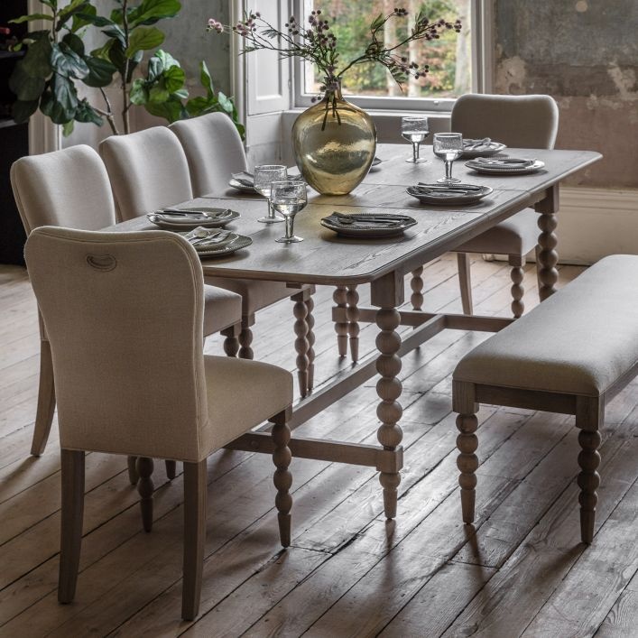Solid wood extending dining table with upholstered chairs in a classic dining room